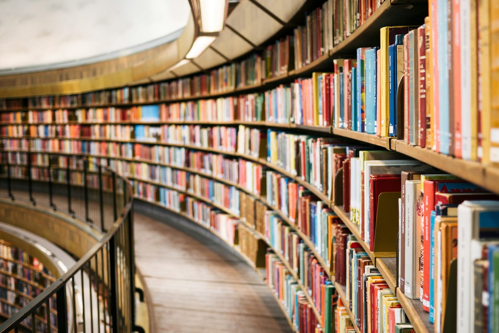 Curved shelves of books in a library reading room