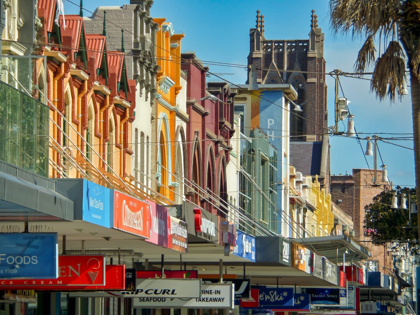 Colourful heritage shopfronts and signage along an Australian high street