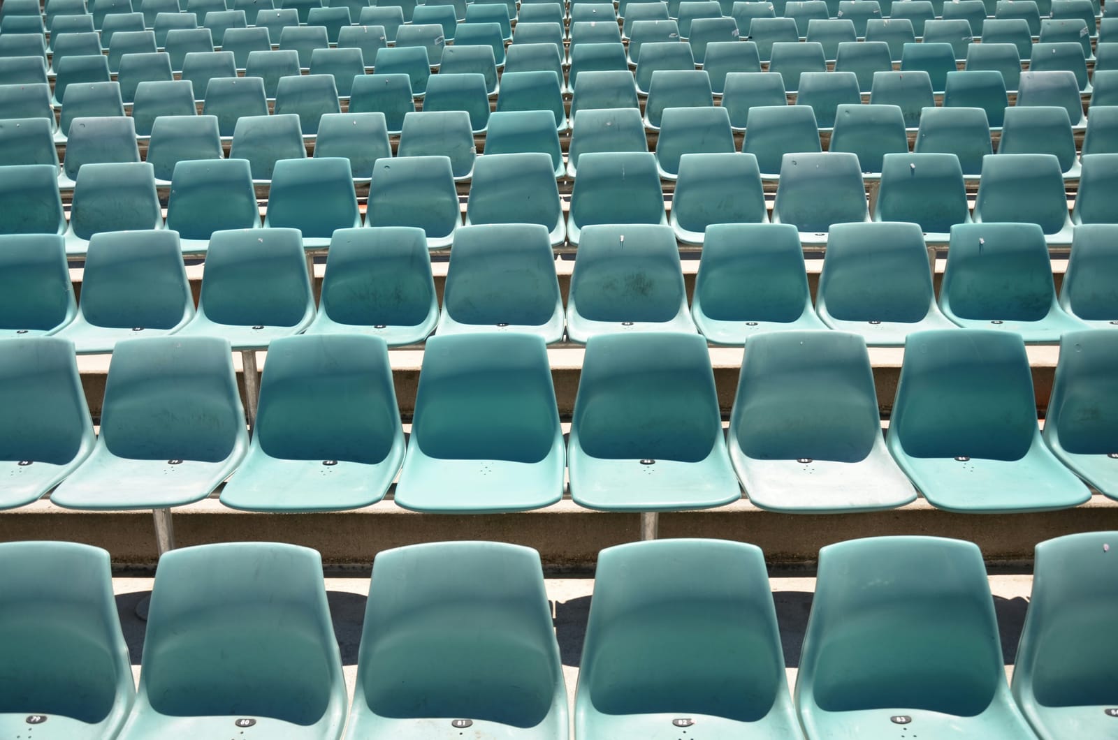 Rows of empty teal stadium seats